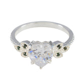 Penelope silver ring with heart shaped clear center stone and small green accents luxurious green gemstone ring